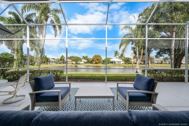 a view of a patio with couches chairs and a potted plant