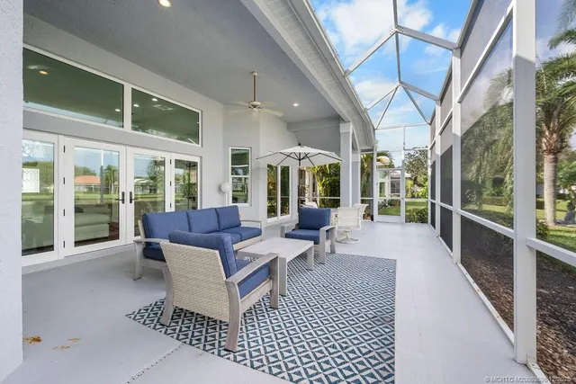 a front view of a house with a garden and trees