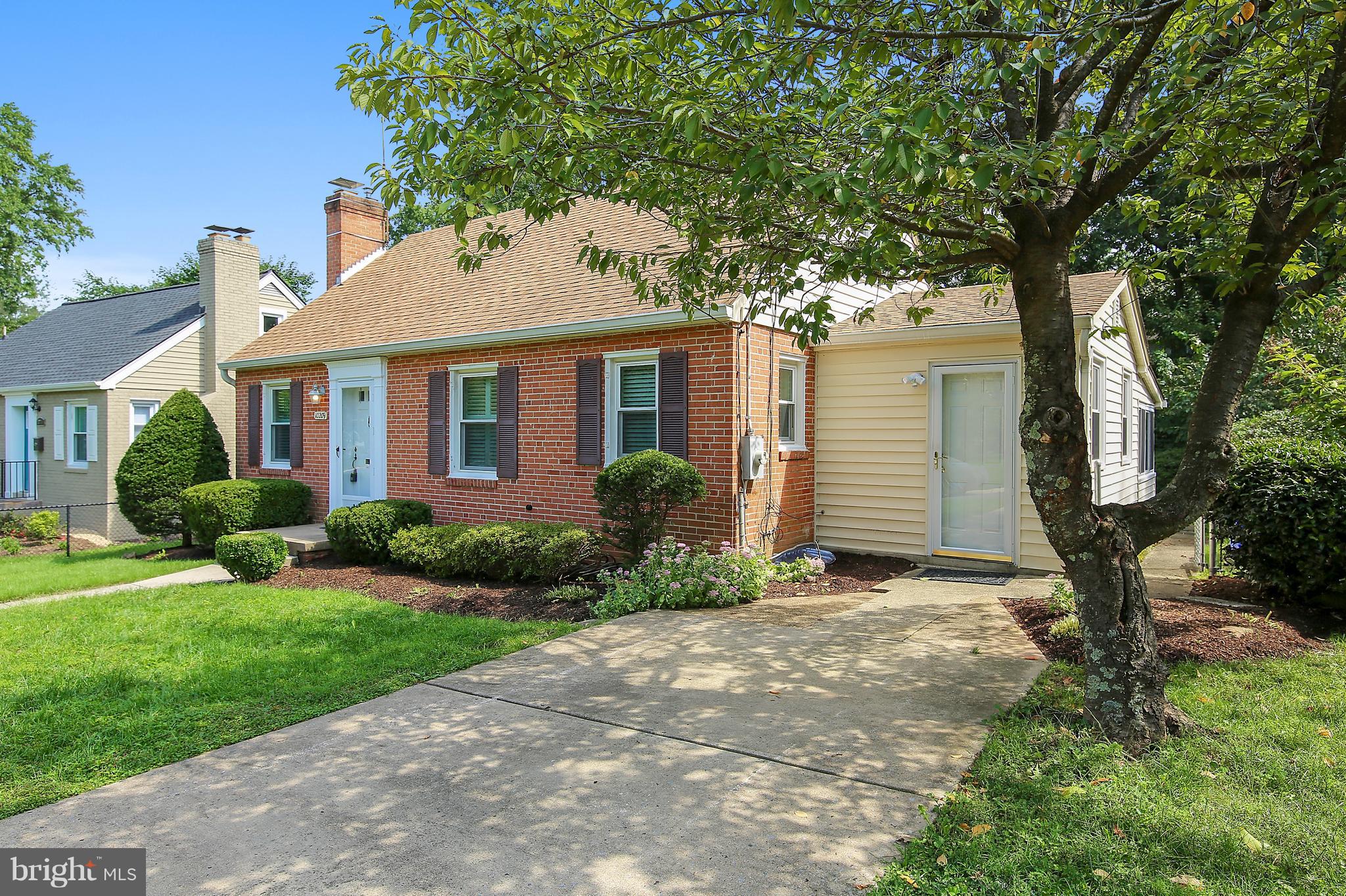 10209 Carson Place Silver Spring, MD 20901 - Photo 2 of 27 a front view of a house with garden