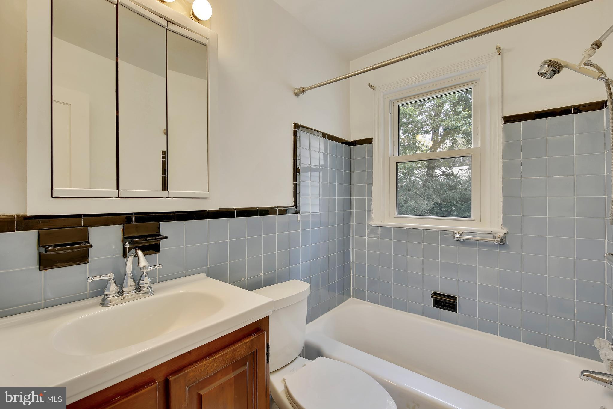10209 Carson Place Silver Spring, MD 20901 - Photo 15 of 27 a bathroom with a sink a toilet and vanity