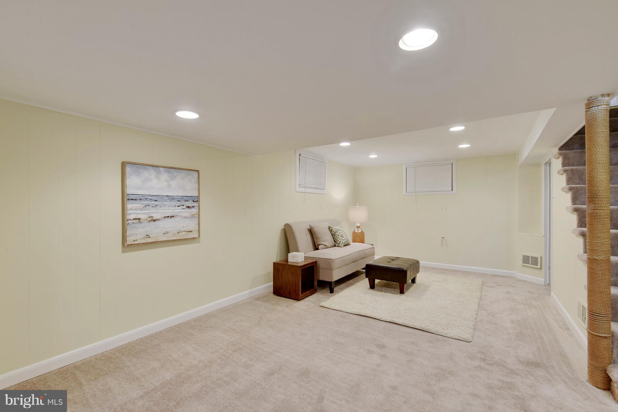 10209 Carson Place Silver Spring, MD 20901 - Photo 23 of 27 a living room with furniture and a painting on the wall