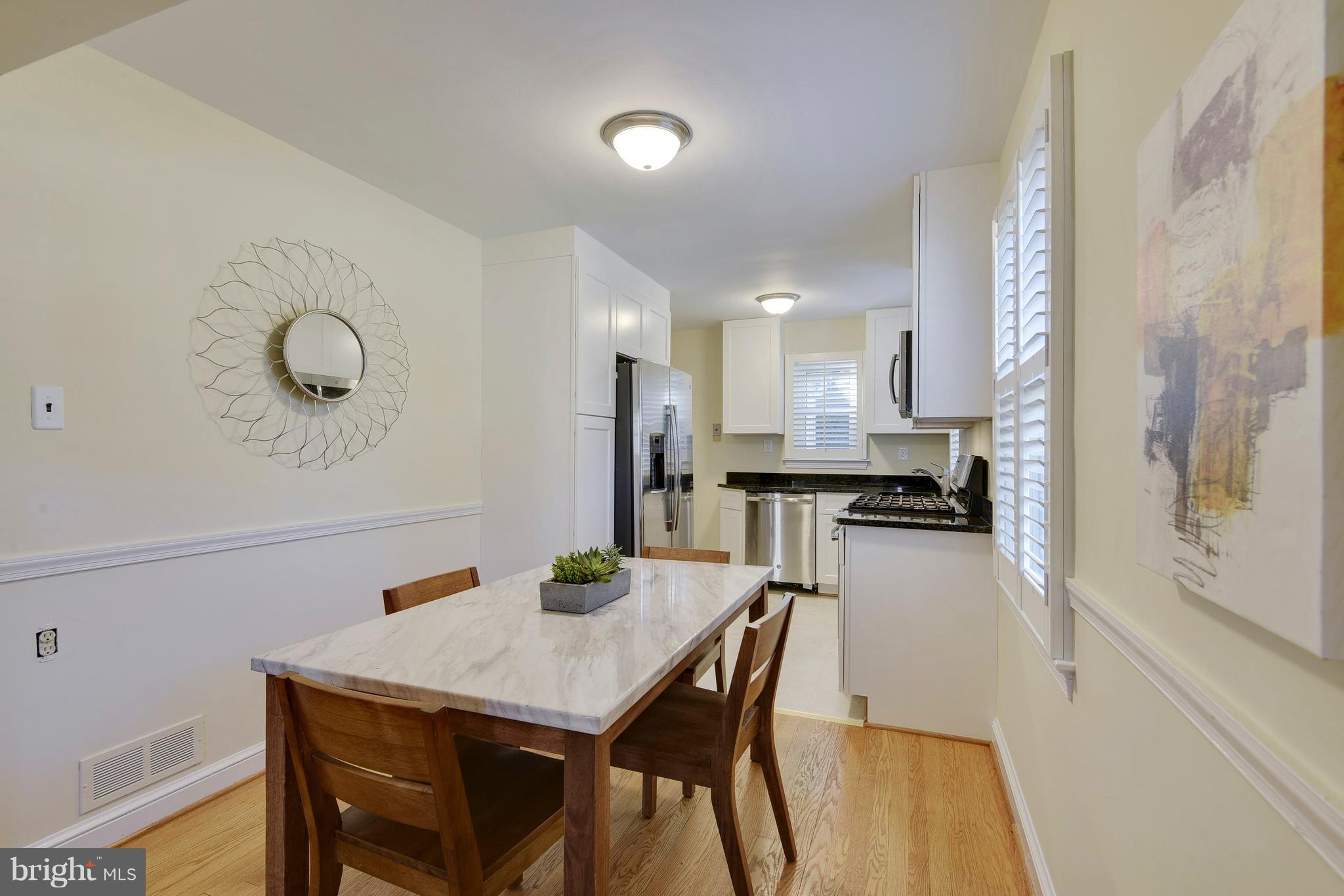 10209 Carson Place Silver Spring, MD 20901 - Photo 5 of 27 a kitchen with a table and chairs in it