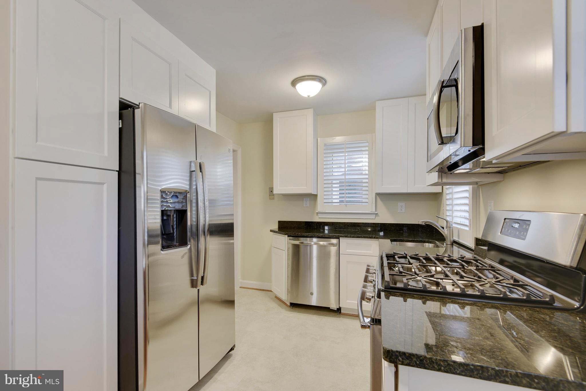 10209 Carson Place Silver Spring, MD 20901 - Photo 6 of 27 a kitchen with stainless steel appliances granite countertop a refrigerator and a stove