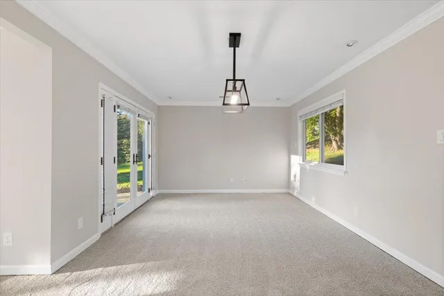 a view of an empty room with a fireplace and a window