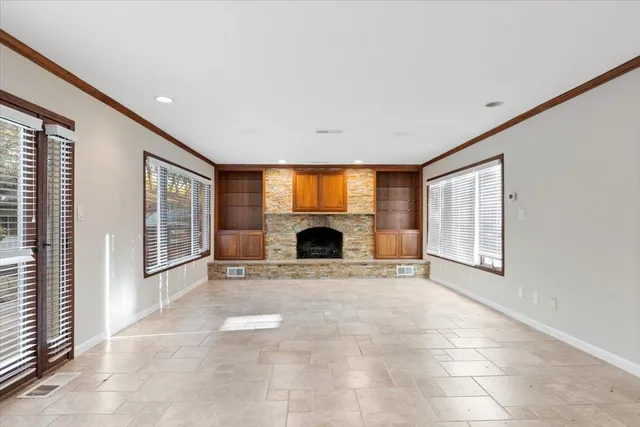 a view of an empty walk in closet and a window
