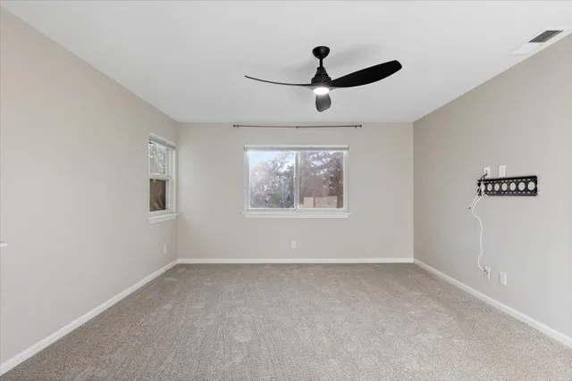 a view of a field of grass and trees