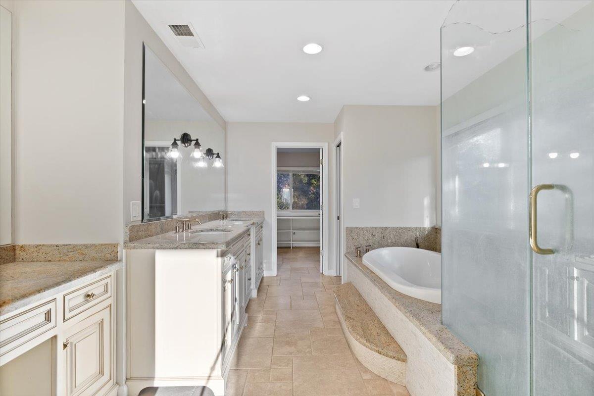 8501 King Road Loomis, CA 95650 - Photo 33 of 89 a spacious bathroom with a granite countertop sink a toilet a bathtub and shower