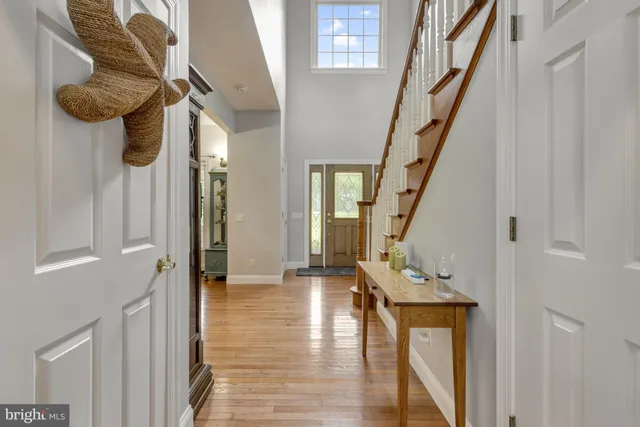 a kitchen with stainless steel appliances granite countertop a refrigerator a stove and a sink