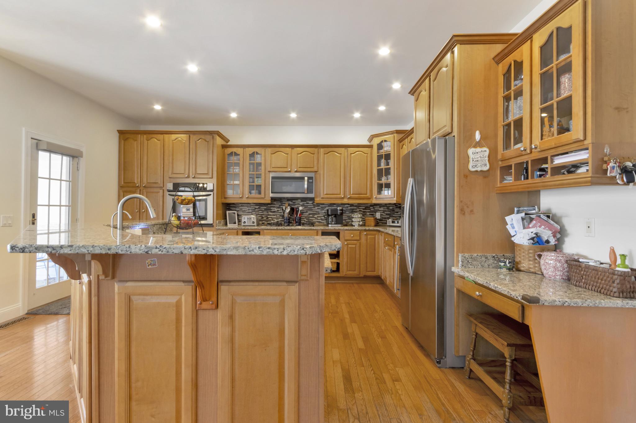 16132 Hudson Road Milton, DE 19968 - Photo 22 of 108 a kitchen with stainless steel appliances granite countertop a sink a stove a refrigerator cabinets and chairs