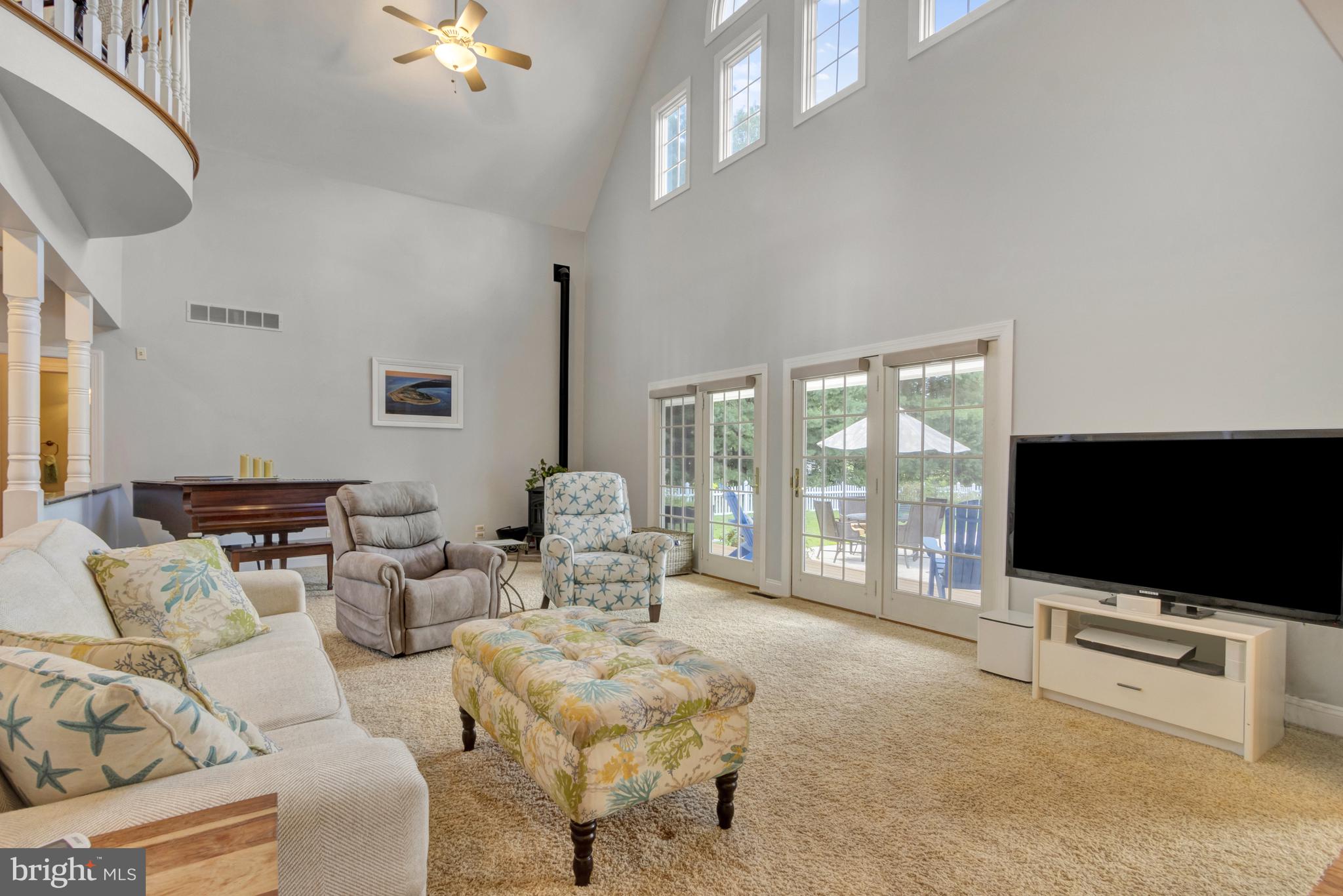 16132 Hudson Road Milton, DE 19968 - Photo 36 of 108 a living room with furniture a flat screen tv and a floor to ceiling window