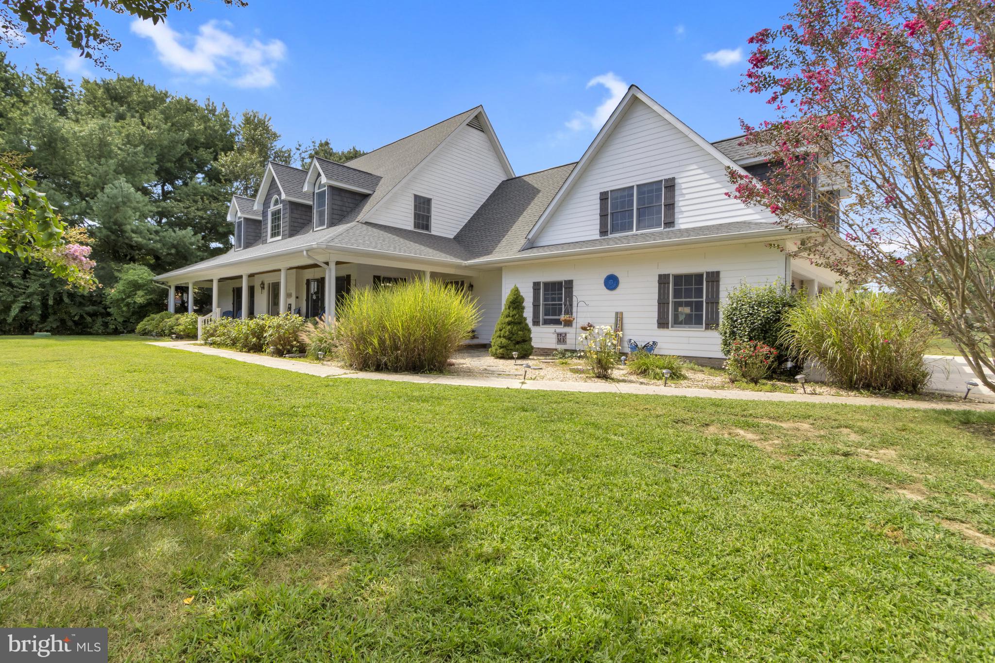 16132 Hudson Road Milton, DE 19968 - Photo 6 of 108 a front view of house with yard and outdoor seating