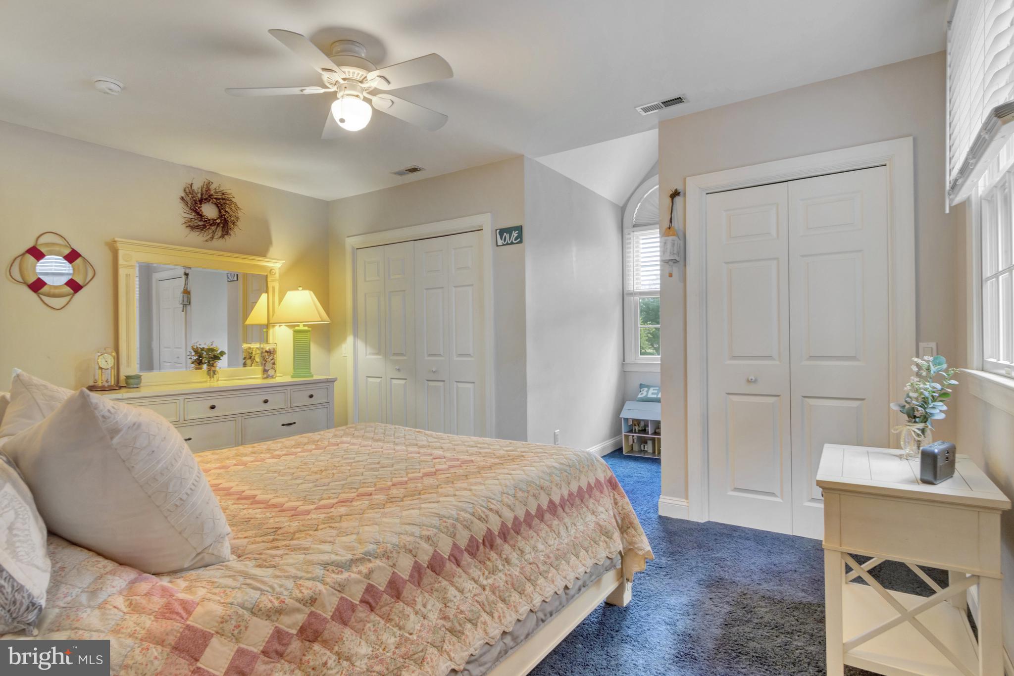 16132 Hudson Road Milton, DE 19968 - Photo 63 of 108 a spacious bedroom with a bed and a chandelier