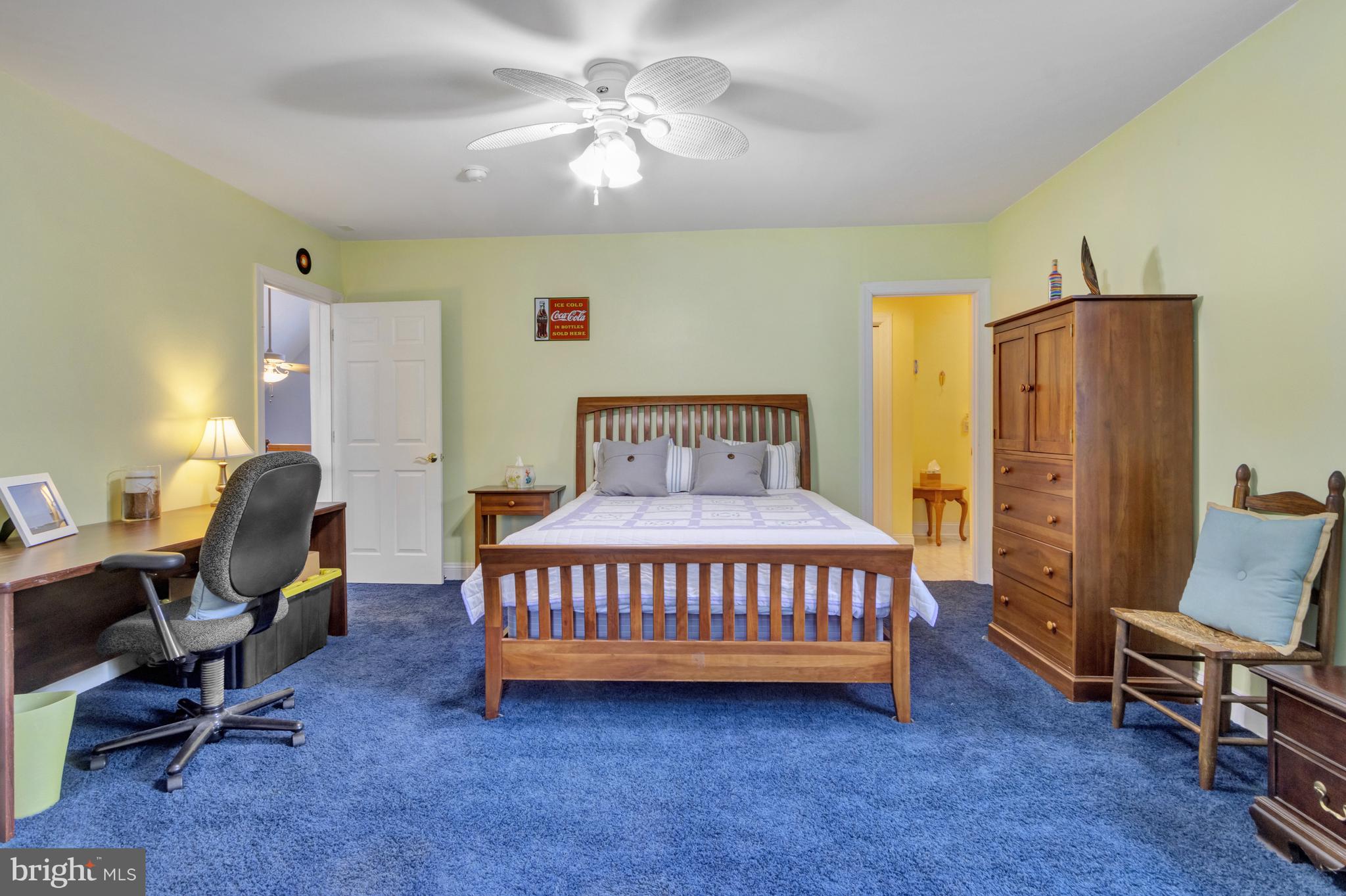 16132 Hudson Road Milton, DE 19968 - Photo 66 of 108 a bedroom with a bed a chair and a chandelier