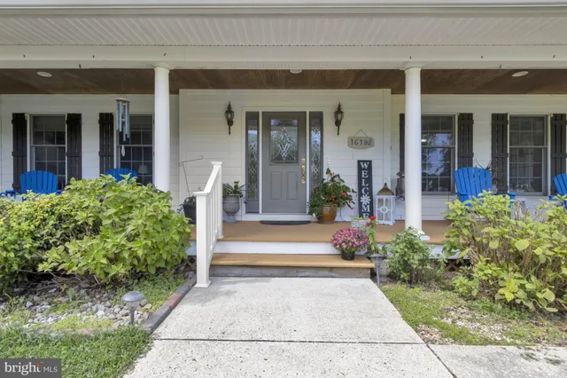 a view of an entryway with wooden floor and staircase