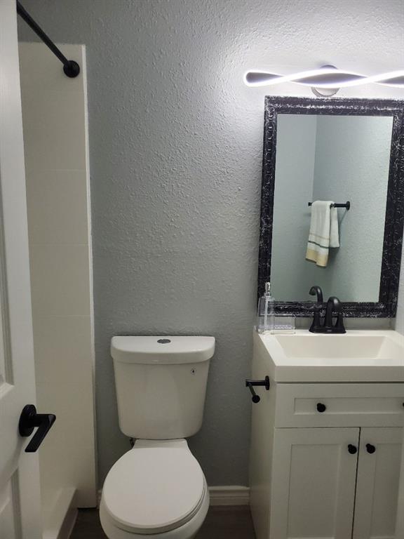 206 Springbranch Drive Garland, TX 75043 - Photo 12 of 12 a bathroom with a toilet sink and mirror