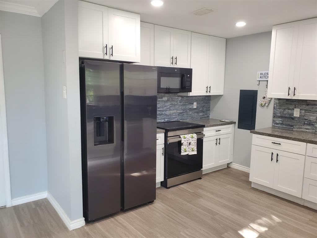 206 Springbranch Drive Garland, TX 75043 - Photo 7 of 12 a kitchen with stainless steel appliances granite countertop a refrigerator and a stove