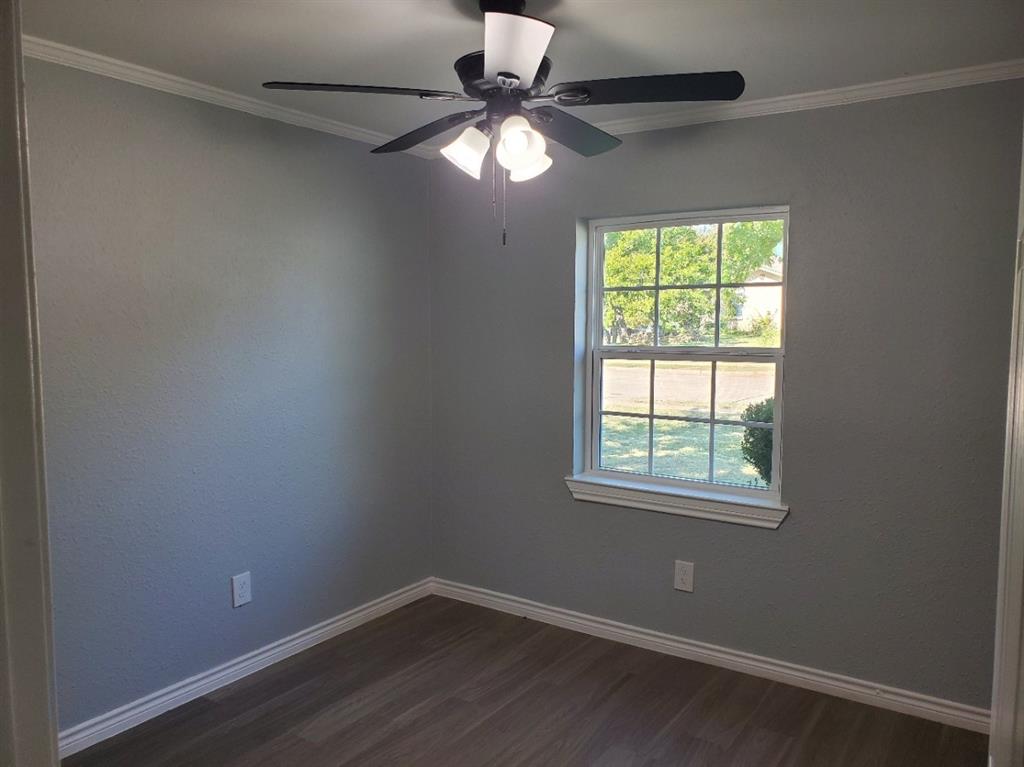 206 Springbranch Drive Garland, TX 75043 - Photo 8 of 12 an empty room with a window and a fan