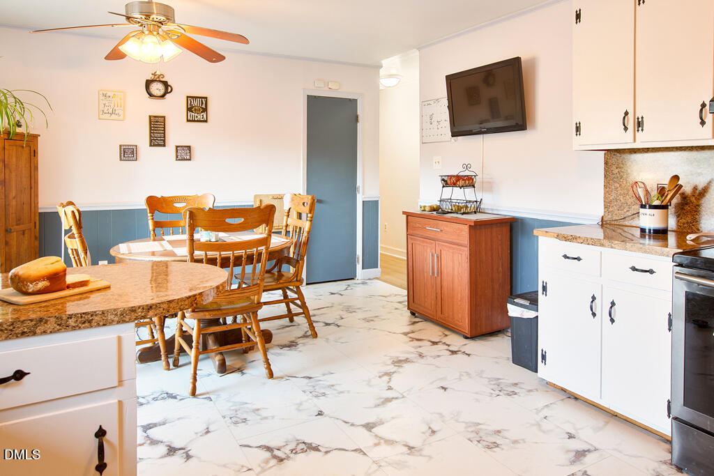 1727 Pinecrest Road Henderson, NC 27536 - Photo 7 of 14 a dining room filled a flat screen tv and kitchen view