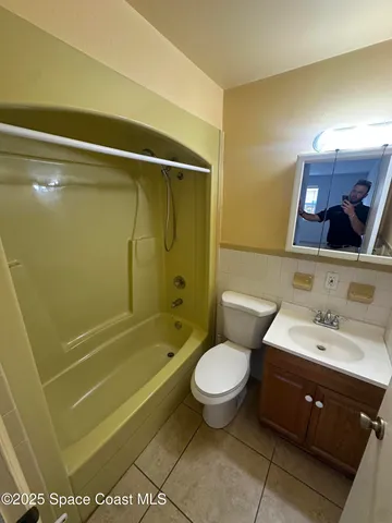 a bathroom with a sink mirror toilet and bathtub