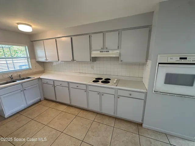 a kitchen with a sink cabinets and window