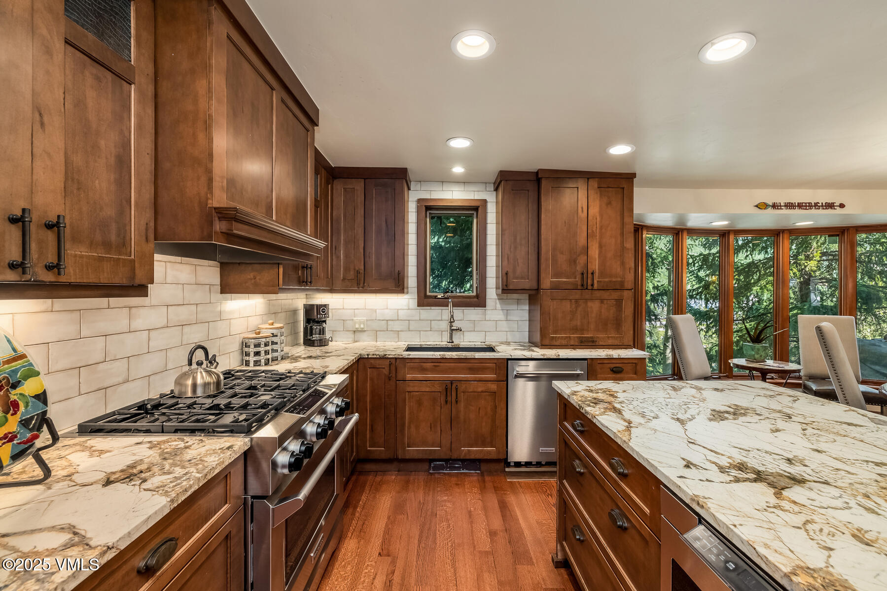 2010 Vermont Road Vail, CO 81657 - Photo 23 of 35 a kitchen with stainless steel appliances granite countertop sink stove top oven and cabinets