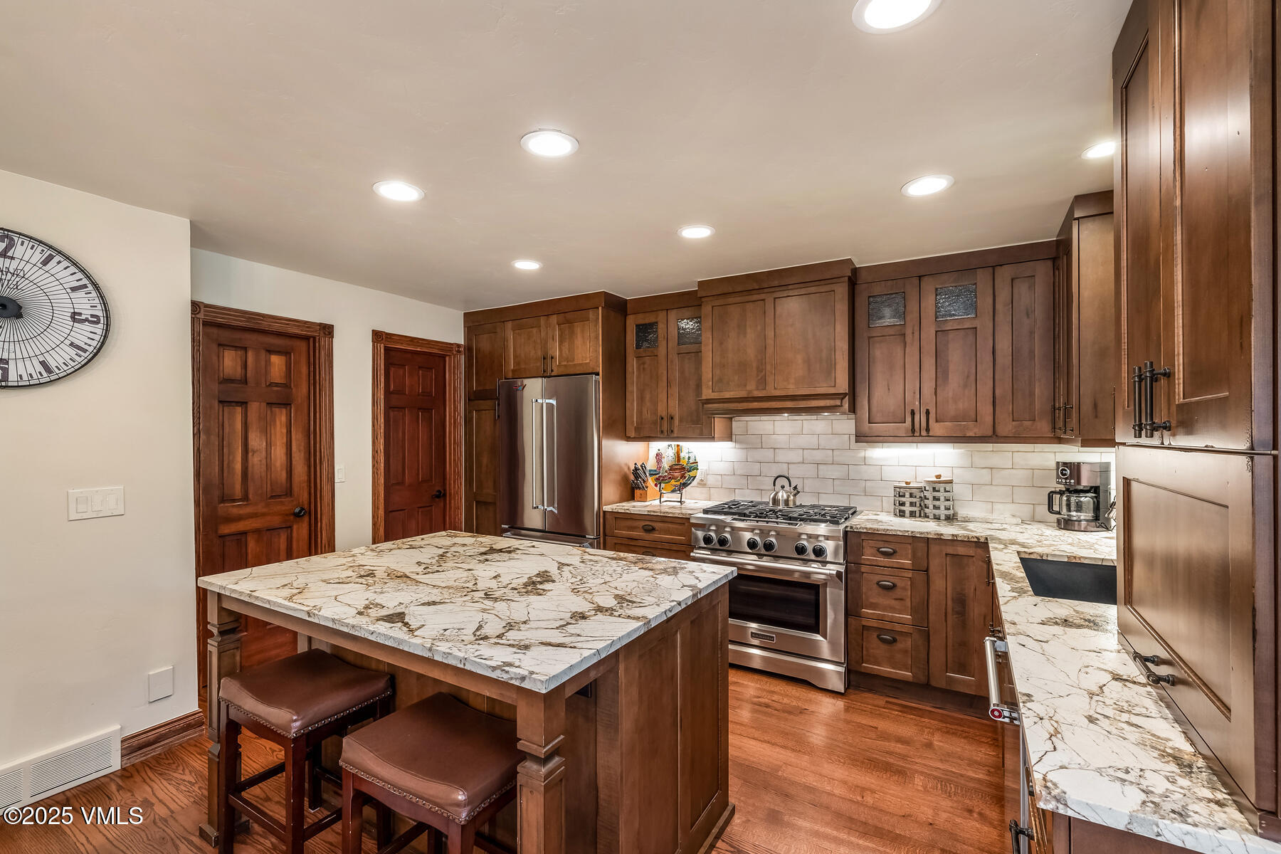 2010 Vermont Road Vail, CO 81657 - Photo 4 of 35 a kitchen with stainless steel appliances granite countertop a stove top oven a sink refrigerator and cabinets