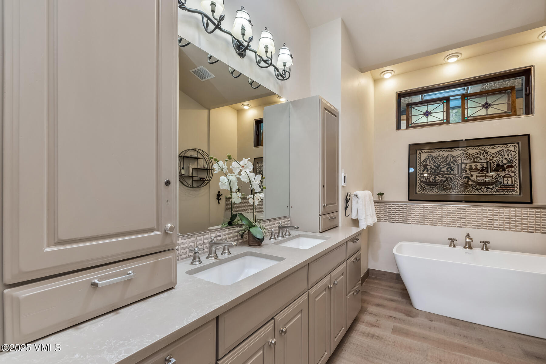 2010 Vermont Road Vail, CO 81657 - Photo 6 of 35 a spacious bathroom with a double vanity sink large mirror and bathtub