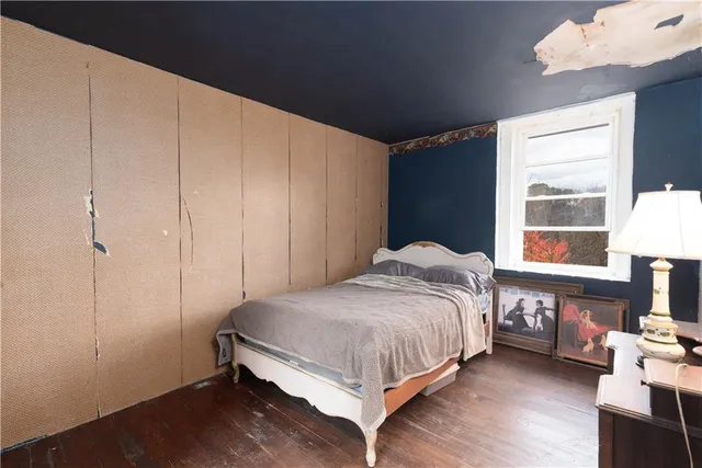 a bedroom with a bed table and a window