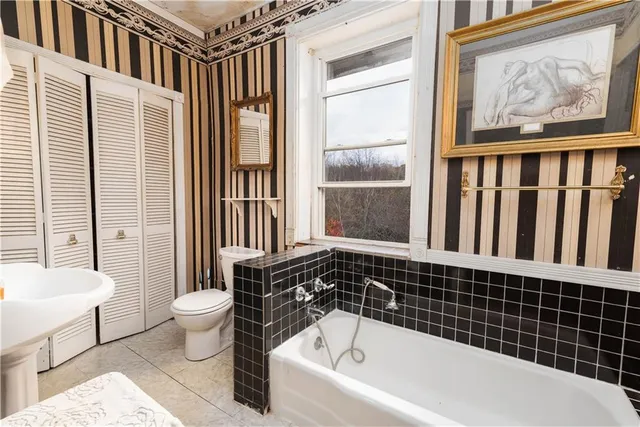 a bathroom with a bathtub and a shower