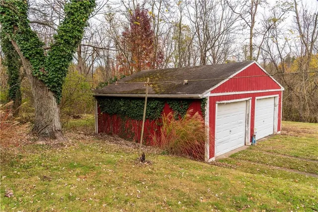 a view of a house with a yard and garage