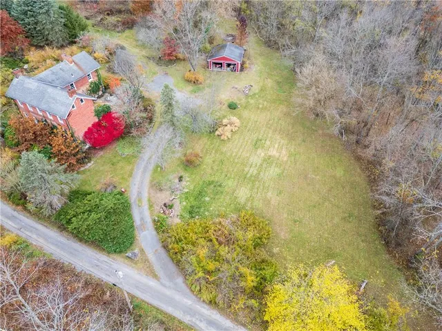 an aerial view of residential house with outdoor space and swimming pool