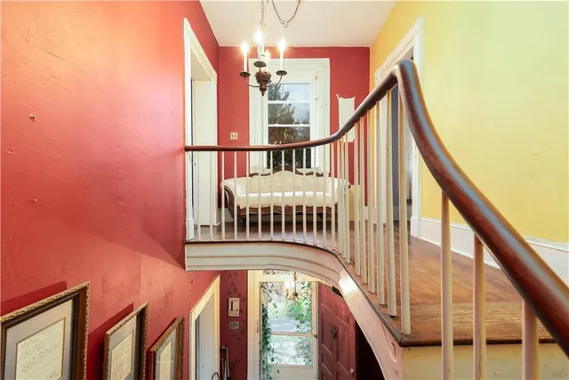 a view of staircase with railing and a window