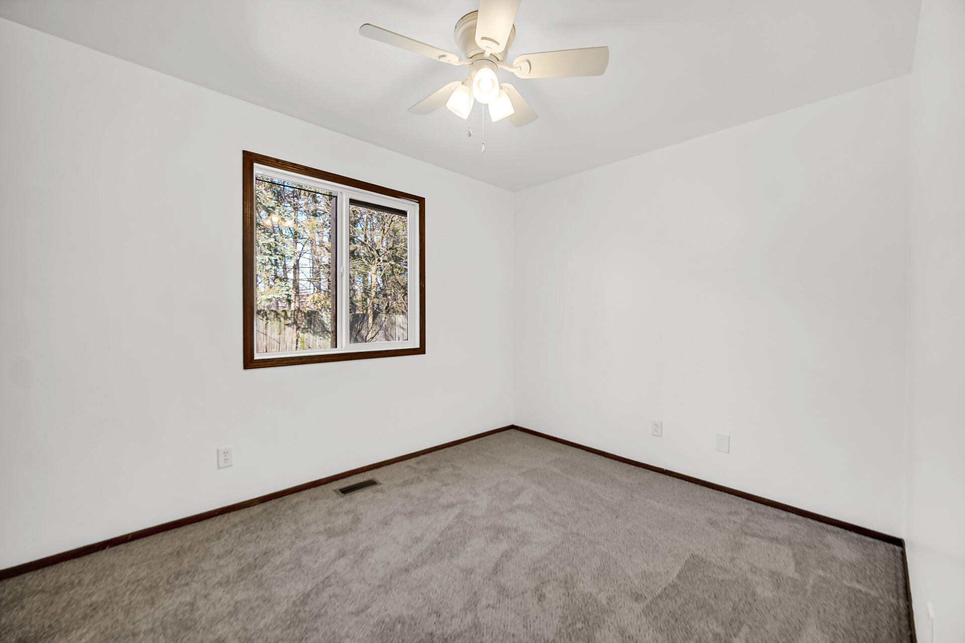 2114 Tupelo Lane Chesterton, IN 46304 - Photo 13 of 23 an empty room with a window and a ceiling fan