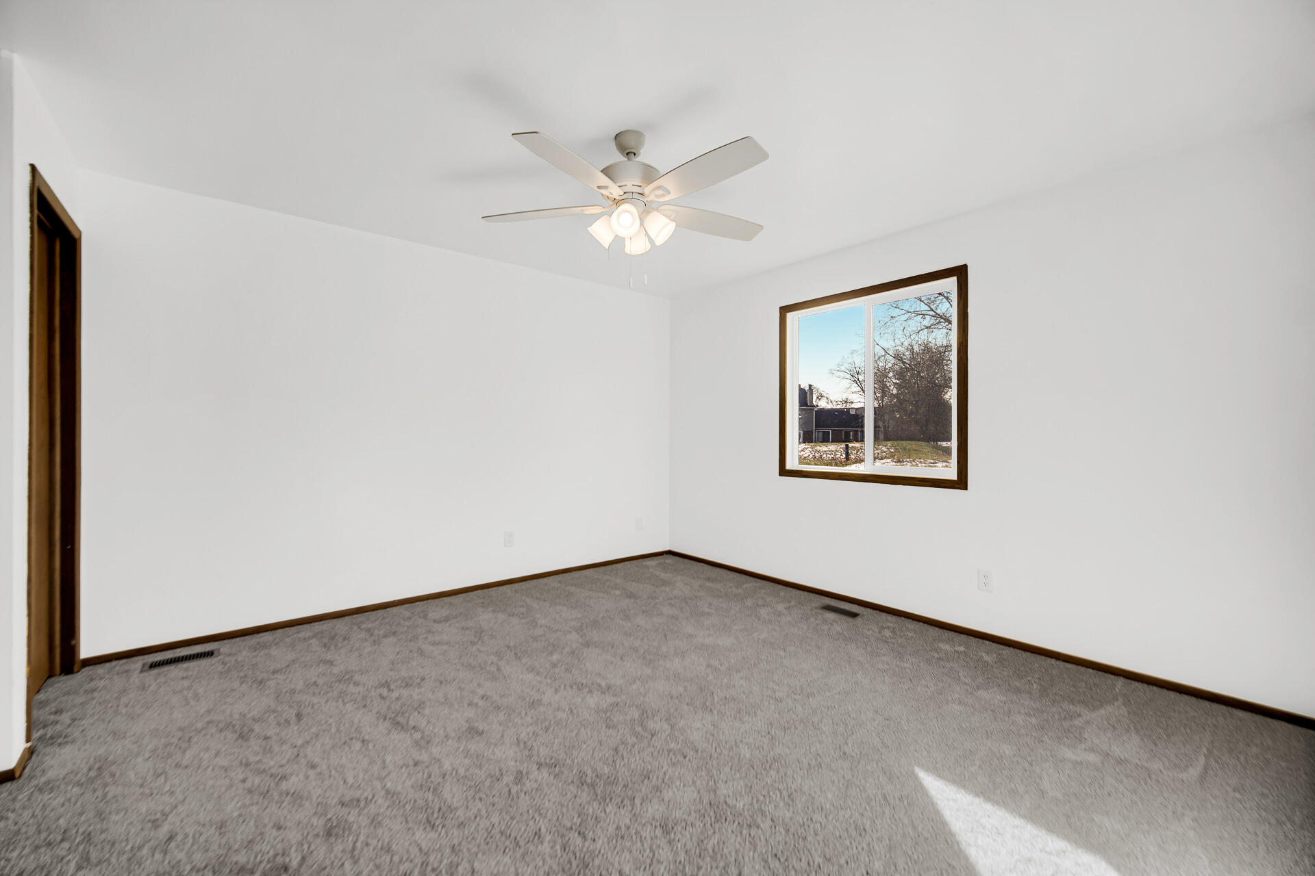 2114 Tupelo Lane Chesterton, IN 46304 - Photo 16 of 23 an empty room with a window and a fan
