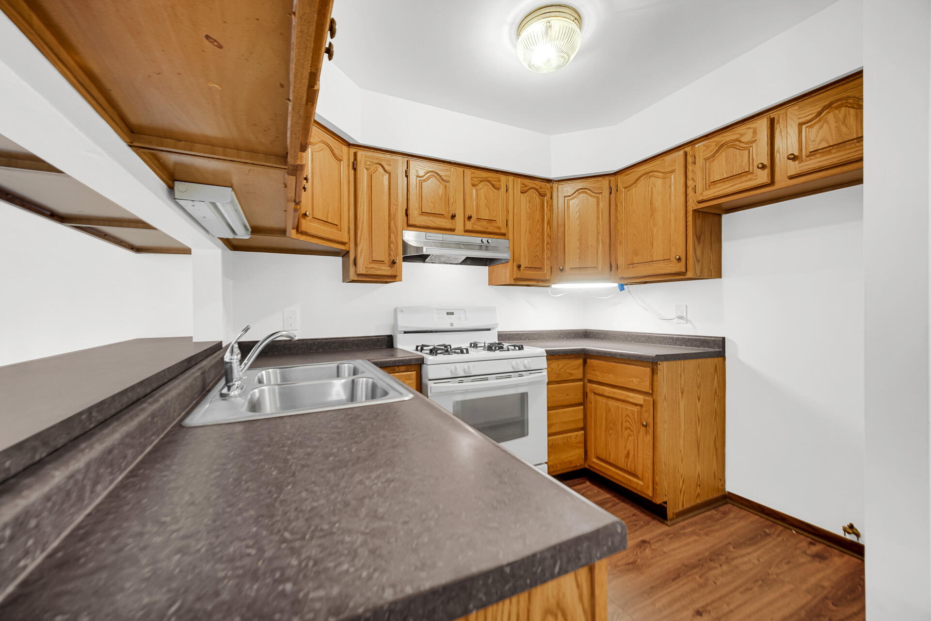 2114 Tupelo Lane Chesterton, IN 46304 - Photo 8 of 23 a kitchen with stainless steel appliances granite countertop a sink a stove and a wooden cabinets