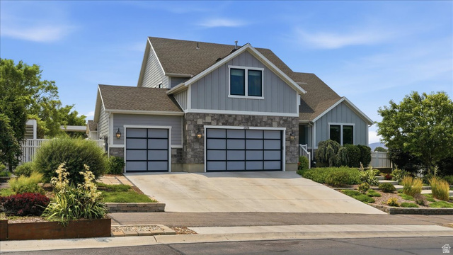 2038 East Ranch Road Eagle Mountain, UT 84005 - Photo 5 of 66 Modern split-level residence featuring light gray siding and stone accents
