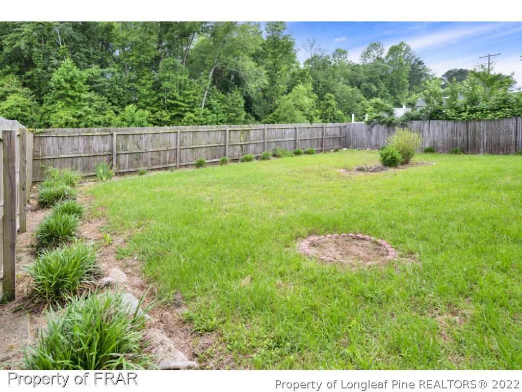 6549 Rhemish Drive Fayetteville, NC 28304 - Photo 5 of 27 a view of a backyard with a trampoline
