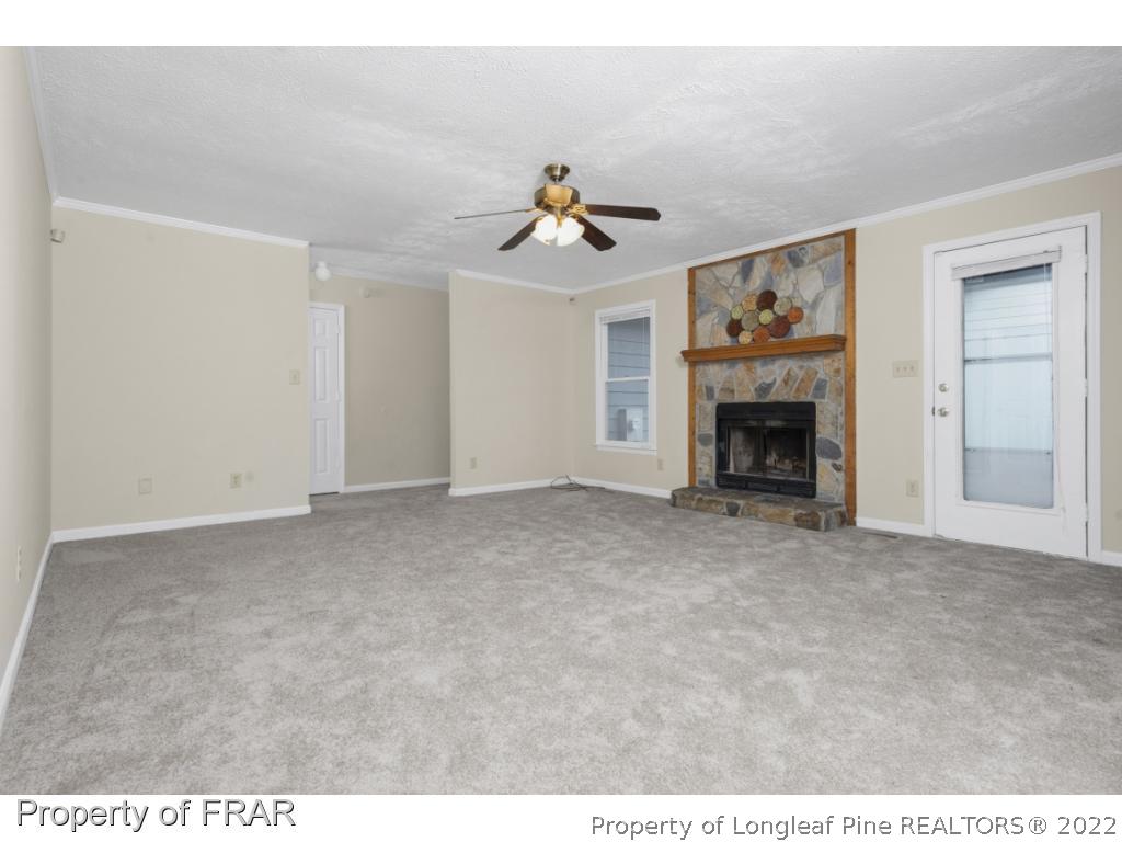 6549 Rhemish Drive Fayetteville, NC 28304 - Photo 7 of 27 a view of empty room with fireplace