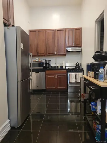 a kitchen with stainless steel appliances a refrigerator a stove a sink and dishwasher