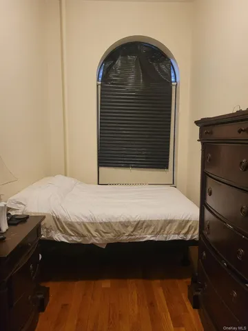 a bed sitting in a bedroom next to a cabinet