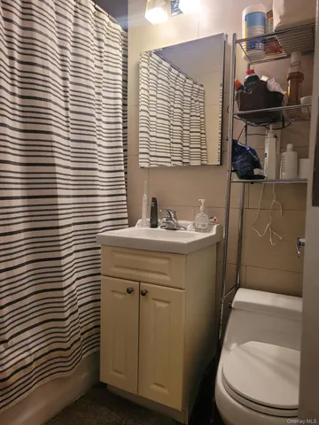 a bathroom with a sink a toilet and vanity