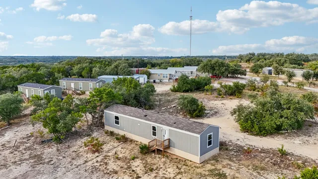 an aerial view of a house with a yard and lake view