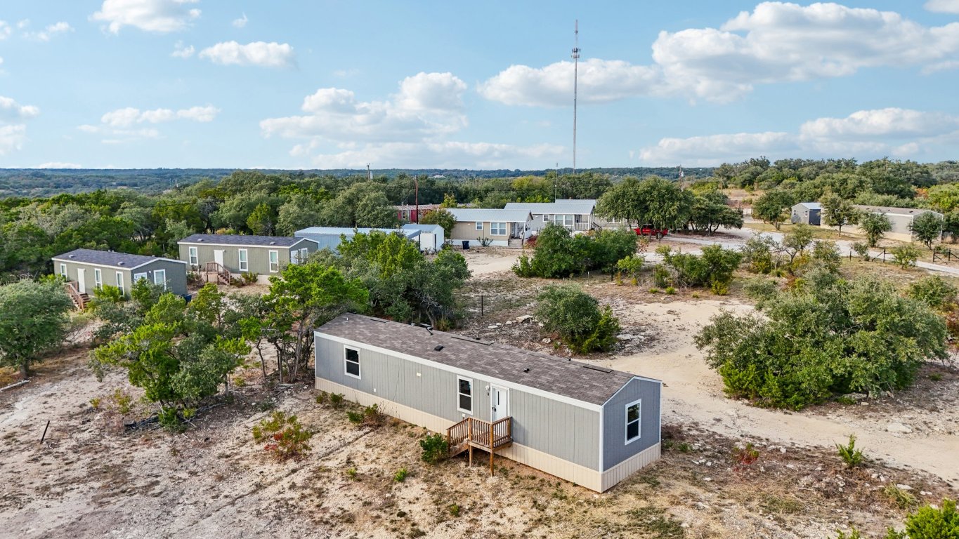 an aerial view of a house with a yard and lake view