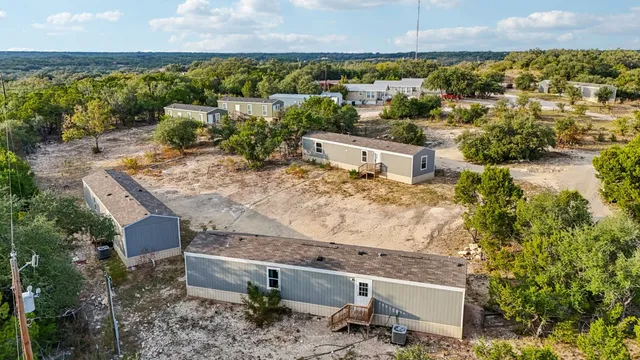an aerial view of a house with a yard