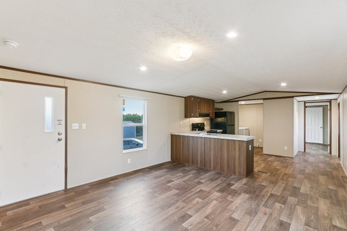 24369-2 Bingham Creek Road, Unit 8 Leander, TX 78641 - Photo 5 of 16 a view of a kitchen with a sink and cabinets