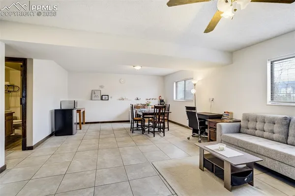 a living room with furniture and a dining table with kitchen view