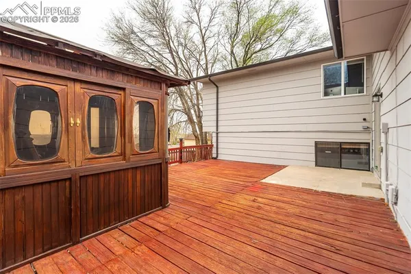 a backyard of a house with wooden floor and fence