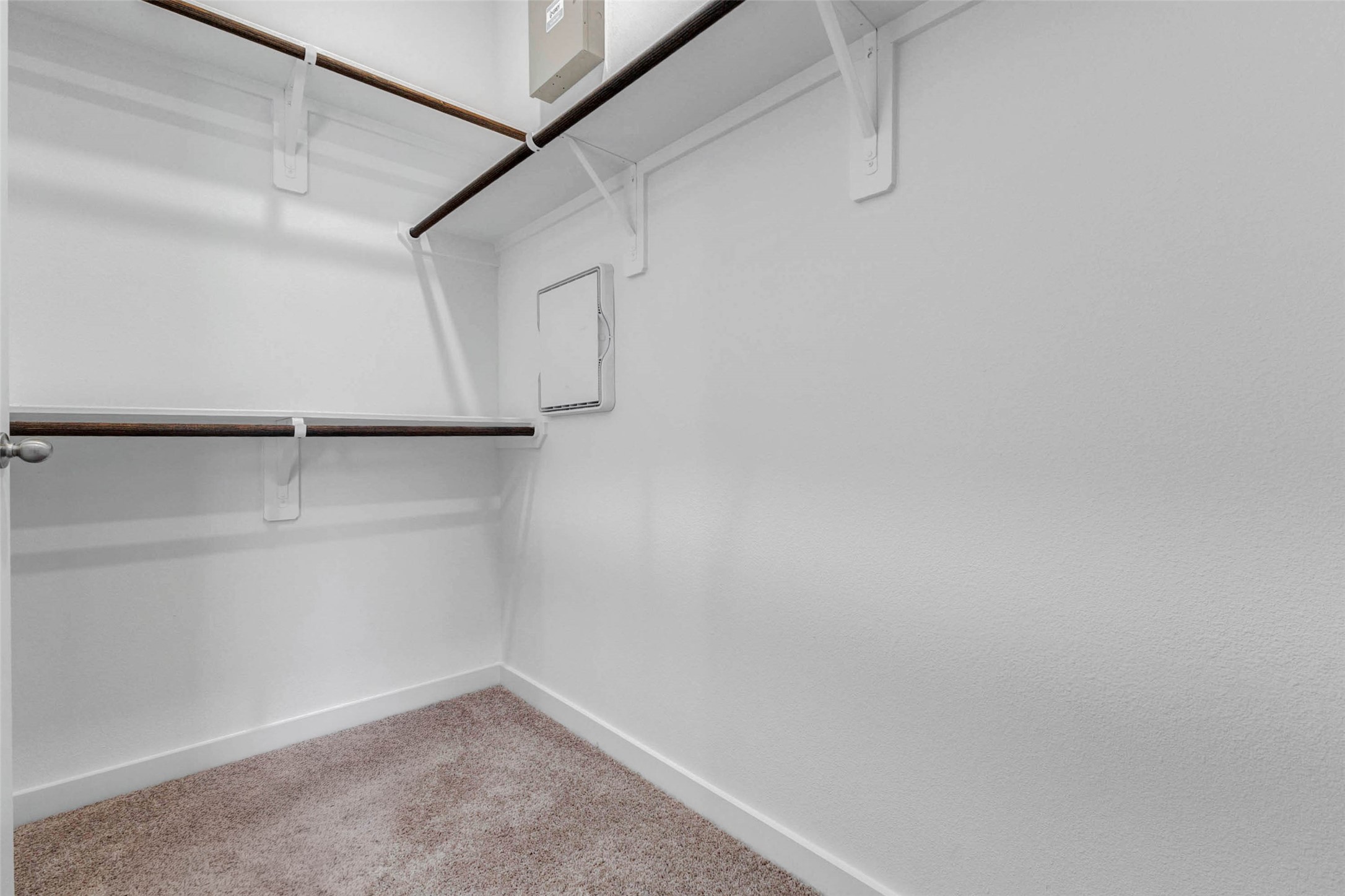 6463 Escondido Drive Rosharon, TX 77583 - Photo 21 of 30 Walk-in closet with built-in hanging rods, upper shelving, and soft carpet underfoot. This storage space provides practical organization for clothing, shoes, accessories, and everyday essentials within the primary suite.