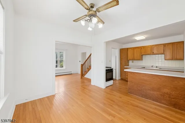 a view of a hallway with wooden floor and closet