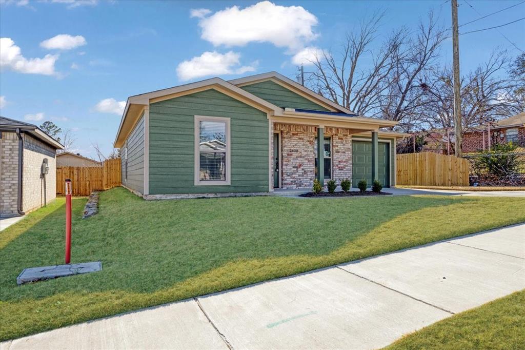 2408 Miller Street Denison, TX 75020 - Photo 2 of 26 a front view of a house with a garden
